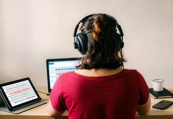 woman working editing audio on laptop 