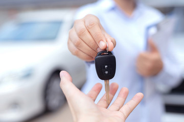 Salesman is carrying the car keys