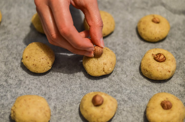 decorating cookies with an hazelnut before baking close up