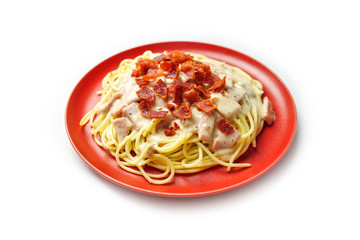 Spaghetti pasta, carbonara cream sauce with ham and bacon Italian cuisine isolated on white background.