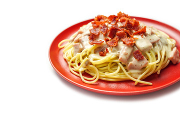 Spaghetti pasta, carbonara cream sauce with ham and bacon Italian cuisine isolated on white background.