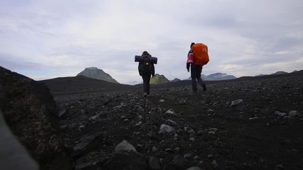 A couple with backpacks doing the 54 km trek from Landmannalaugar, Iceland