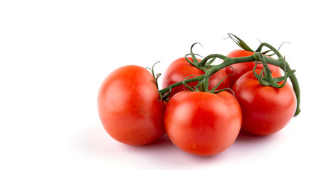 ripe tomatoes on a spout, white insulated background, close-up