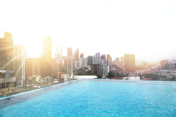 Fototapeta na wymiar Sunny day sunrise at the luxurious hotel with the infinity pool in Kuala Lumpur in Malaysia.