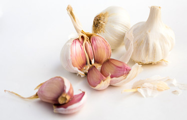 garlic heads and cloves on white background