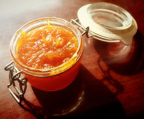 Food still life: delicious homemade orange marmalade on a wooden table