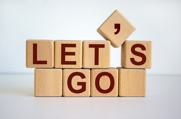 Concept word 'lets go' on cubes on a beautiful white background.