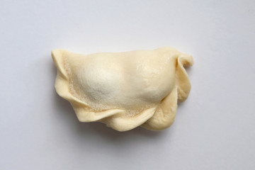 Raw dumpling with cherry top view. Dumplings with cherries on a white background. Raw dough for dumplings, freezing.