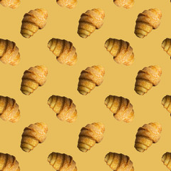 Seamless pattern of croissants on a yellow background.