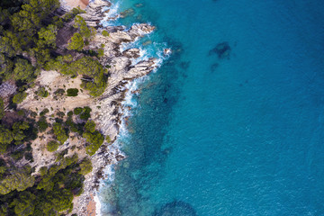 aerial top view of a clear ocean with sea cliffs