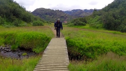 A young man with backpack starting the 54 km trek from Landmannalaugar, Iceland