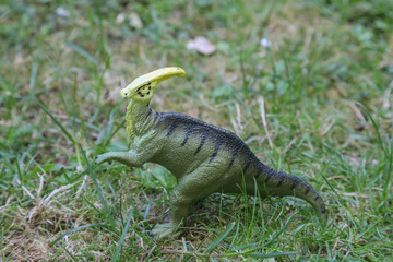 parasaurolophus dinosaur in green grass background jurassic world