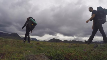 A couple with their backpacks on the 54 km trek from Landmannalaugar, Iceland