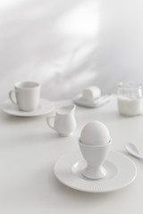 Minimal white breakfast, goat cheese, milk, plain yogurt, boiled egg