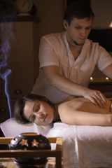 Beautiful girl in a massage parlor for back health treatments and aromatherapy