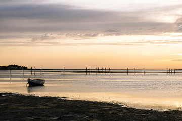 traditional wooden boat at sunset in the beach
