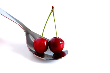 Cherries in a spoon. Suitable for  advertising backgrounds. Vitamins