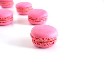 Macaroons are pink on a white background. Suitable for advertising backgrounds.