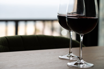 Luxury red wine. Delicious drinks, made from delicious grapes in wine glass on the table. restaurant close up. red wine on table. plate with wine on table. restaurant open. catering industry