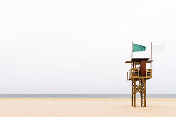 wooden life guard tower on an empty morning beach