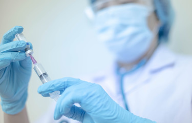 Syringe medical injection in hand holding with medicine dose vaccination equipment with needle. vaccination to patient for coronavirus (COVID-19) protection.