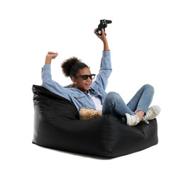 African-American teenage girl playing video game on white background