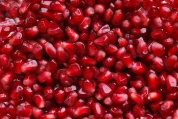 Background of many fresh organic pomegranate seeds, macro photography