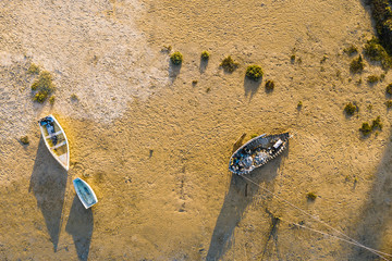 some boats on the ground at low tide