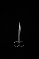 A scissor in a dark copy space background. product photography.