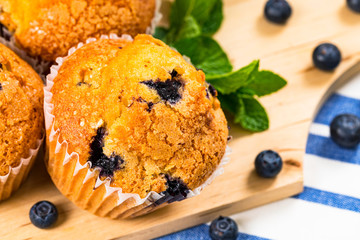 Blueberry Muffins with Fresh Blueberries on Wooden Background. Selective focus.