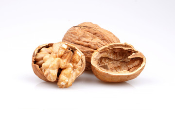 Organic walnuts and cracked walnut, isolated on white background