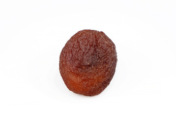 Organic and fresh dried black apricot close-up isolated on a white background.