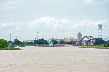 boats and barges at industrial canal lock in new orleans