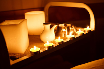 massage oil and burning candles in the massage parlor