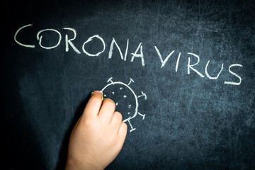 Coronavirus, kid hand-drawn text with chalk on blackboard. School concept
