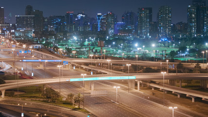 Fototapeta na wymiar Aerial night view of empty highway and interchange without cars in Dubai