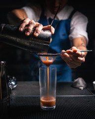 Bartender pouring a cocktail drink 