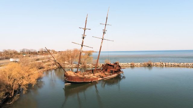 Sunken burned out rusty party boat from a drone