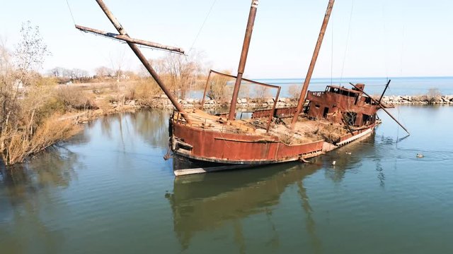 Drone fly past of sunken shipwreck, geese playing