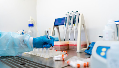 Laboratory assistants analyzing blood sample. Assistance in gloves. Prevention. Pneumonia diagnosing. COVID-19 and coronavirus identification. Pandemic.