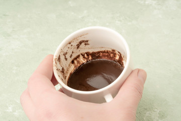 hand holding a cup of coffee for fortune telling