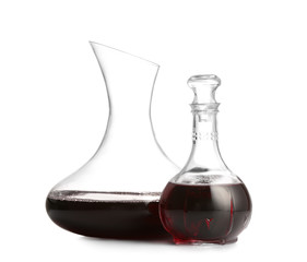 Decanters of wine on white background
