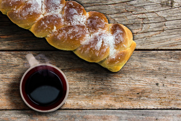 Breakfast photo top view a cup of coffee and an easter sweet bread
