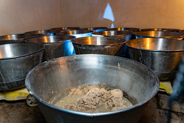 Raw puff pastry. Preparing pastry in basin. First step of professional production. Close up.