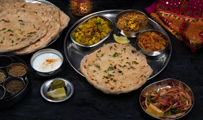 North Indian vegetarian  food served in thali style along with garlic butter naan