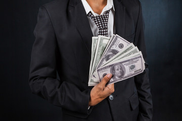 Business Man Displaying a Spread of Cash