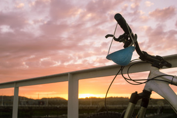 bicycle with a sanitary mask hanging on the handle