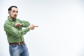 Professional businessman pointing at a new product on his side, promoting it over white background.
