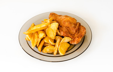 Homemade fried chicken with french fries on a glass plate.