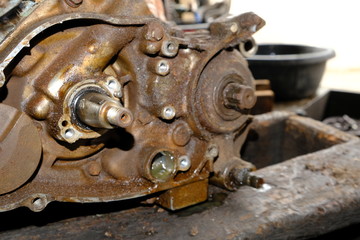 The motorcycle's engine is serviced or repaired by a mechanic.	